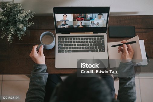 istock An asian chinese male working at home using laptop video conference call meeting with headset 1221598194