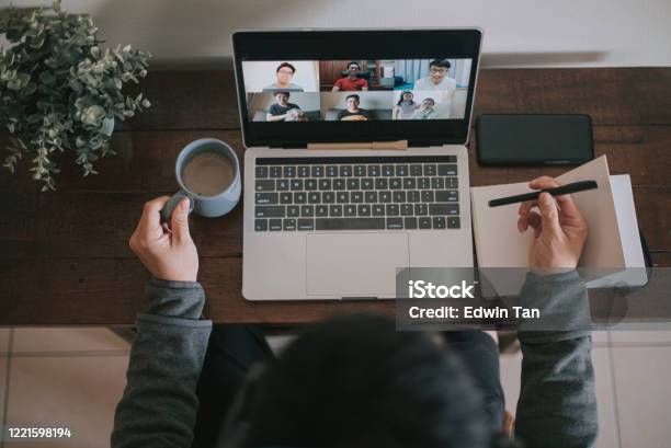 An Asian Chinese Male Working At Home Using Laptop Video Conference Call Meeting With Headset Stock Photo - Download Image Now