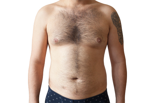 Cuerpo peludo de un hombre, estómago y pecho, pelo teliza excesiva, depilación, lunares, ombligo con sobrepeso. photo