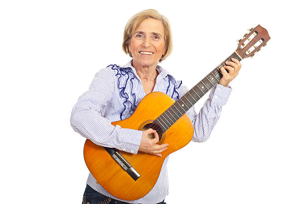 istock Smiling aged woman with acoustic guitar 122159929