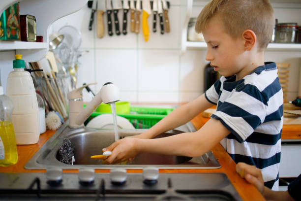 istock Boy Washing brushes in the sink 1221600008