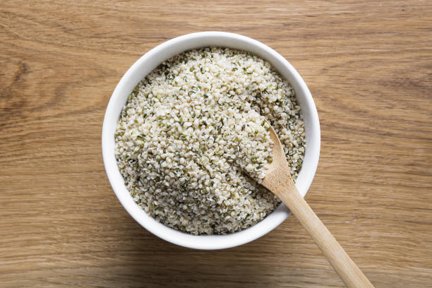 istock Organic kernels hemp in bowl on wooden board.View from above. 1221600257