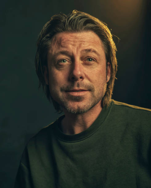 istock Middle aged man with stubble beard in green sweater. 1221601818