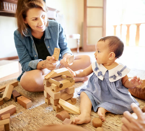 istock Mother playing with her daughter at home 1221603090
