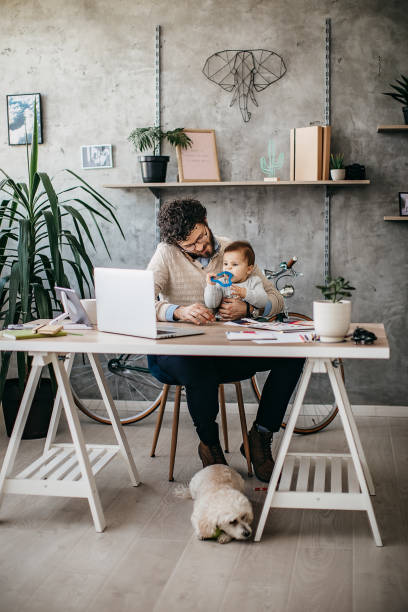 istock Father, Baby and dog in home office 1221605185