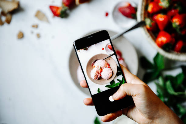 istock Chef photographing strawberry ice-cream 1221605232