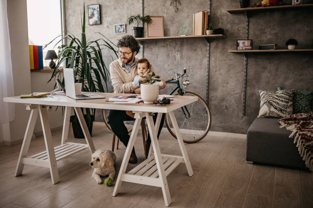 istock Father, Baby and dog in home office 1221605450