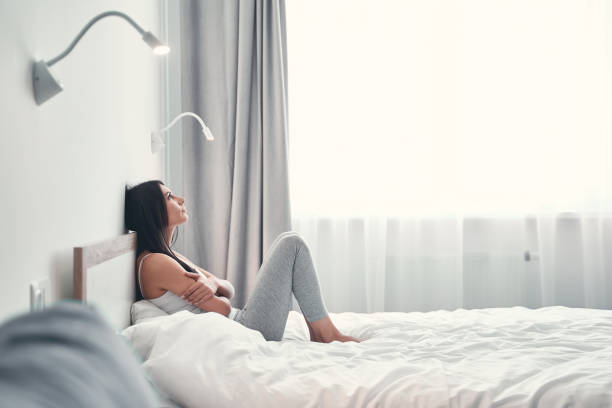 istock Negative delighted young female sitting in her room 1221605606