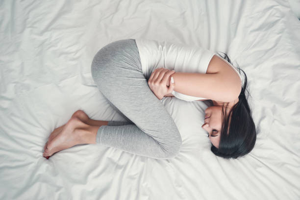 istock Young tender female person embracing herself during sleep 1221605661