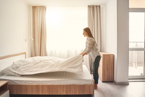 istock Positive delighted brunette woman changing new linens 1221605739