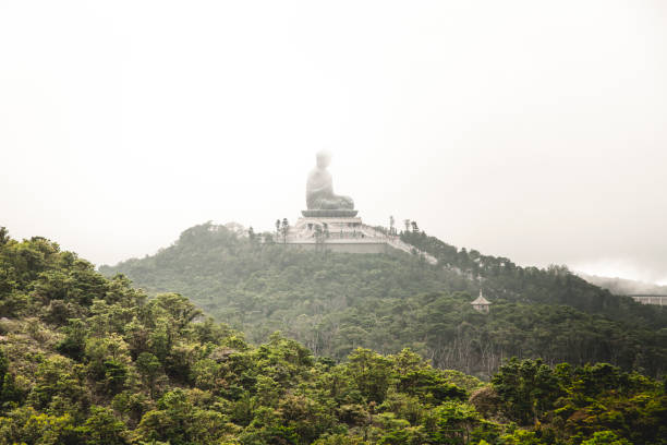 The Tian Tan Buddha on the mountain in Ngong Ping, Hong Kong in a cloudy day.
