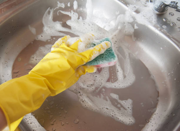 istock hand in glove with a sponge 1221609925