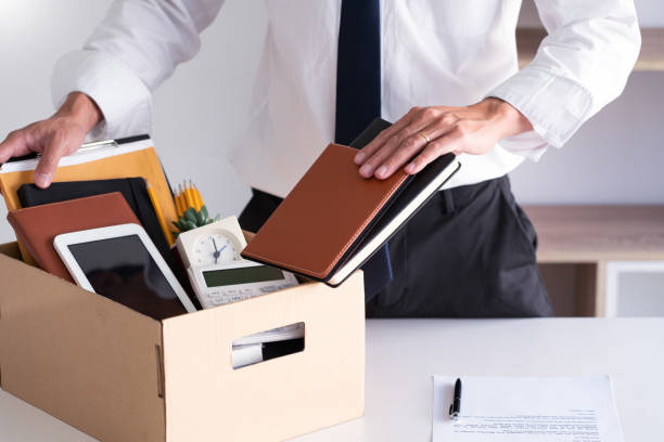 istock Midsection Of Businessman Packing In Office 1221611070
