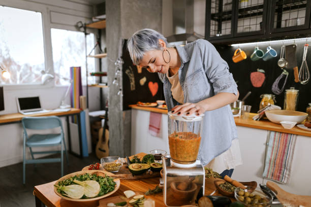 istock Woman preparing vegetable juice 1221611197