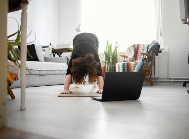 istock Young woman practicing yoga at home 1221611495