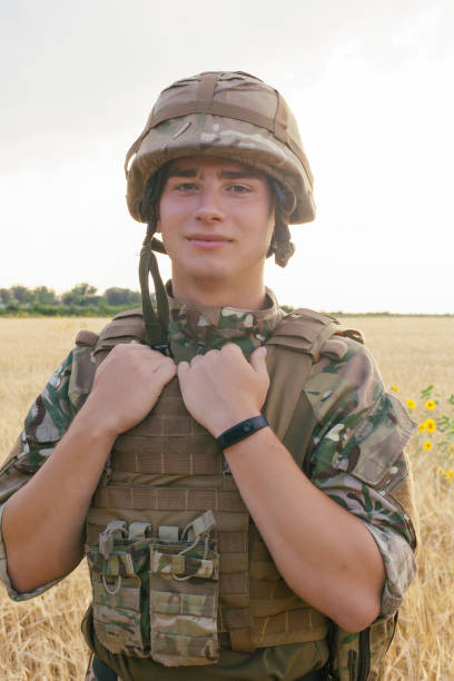 istock Soldier man standing against a field 1221612566
