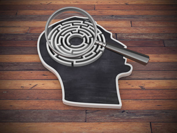 istock Human Head Shape with Maze and Magnifying Glass on Wood Floor - 3D Rendering 1221612701