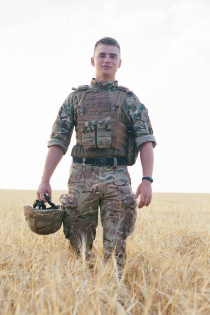istock Soldier man standing against a field 1221612802