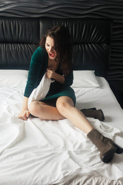 istock Screaming Angry Woman Sitting on Couch at home 1221613046