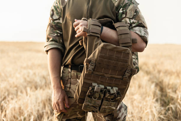 istock Soldier man standing against a field 1221615801