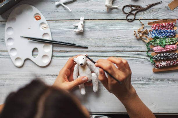 istock Woman making wool soft toys 1221615984