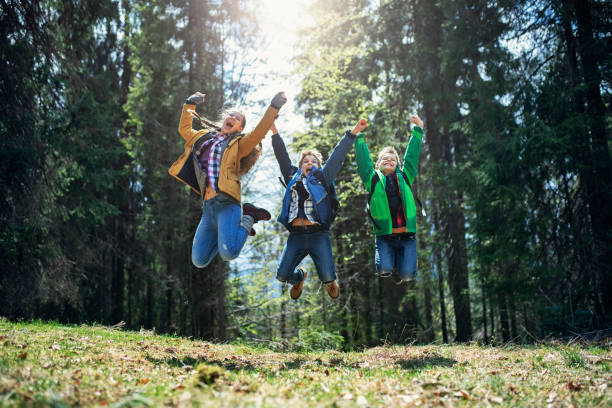 istock Happy little hikers jumping with joy 1221617269