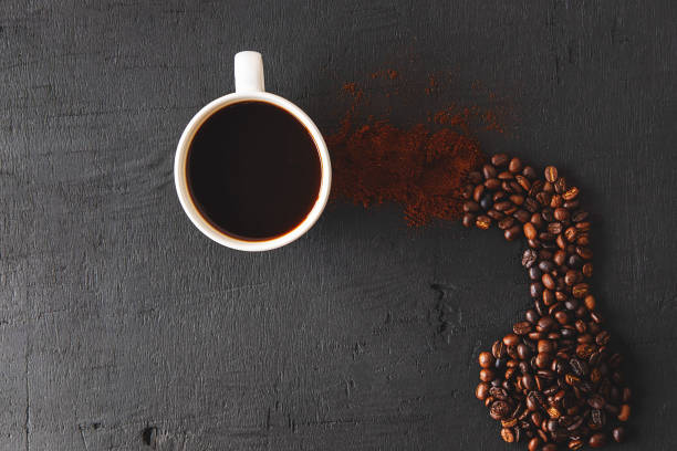 istock Hot coffee with coffee powder and coffee beans on a black background 1221617851