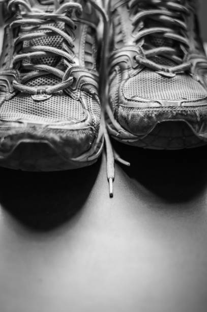 istock Old dirty sneakers close up, selective focus, black and white. 1221619250