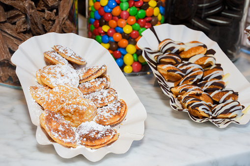 Street food dessert: waffles and small pancakes with varied toppings and fruits on top. Fresh Food Buffet Brunch Catering Dining Eating Party Sharing Concept