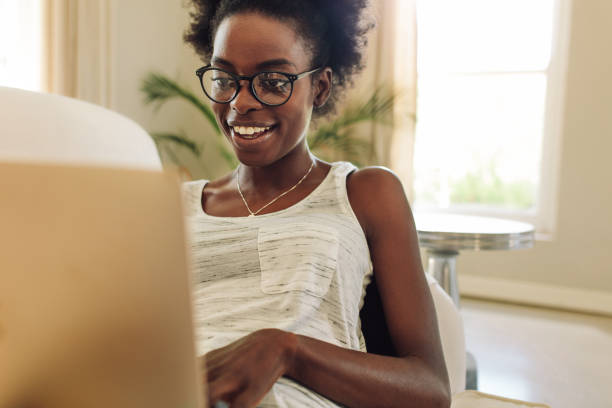 istock Happy woman relaxing on sofa using laptop 1221619577