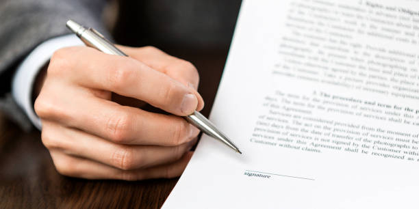 istock The hand with the pen points to an empty space for the signature 1221620447
