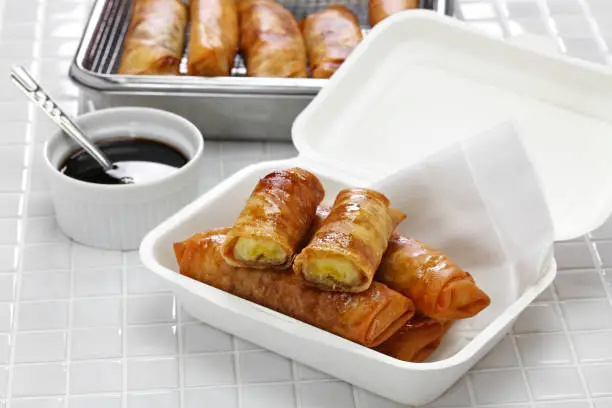 turon, filipino banana spring rolls in takeaway paper food container