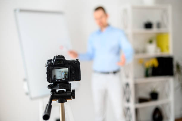 istock A guy in a smart casual wear records vlogs 1221622703