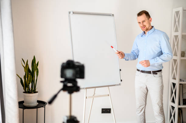 istock A guy in a smart casual wear records vlogs 1221622706