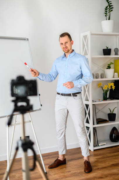 istock A guy in a smart casual wear records vlogs 1221622712