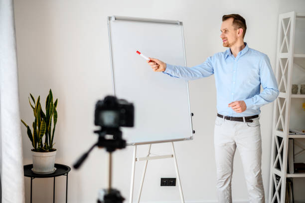 istock A guy in a smart casual wear records vlogs 1221622714