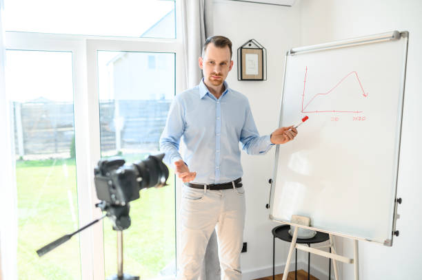 istock A guy in a smart casual wear records vlogs 1221622717