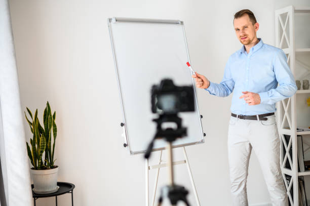 istock A guy in a smart casual wear records vlogs 1221622719