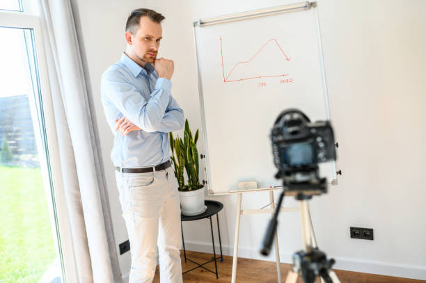 istock A guy in a smart casual wear records vlogs 1221622721