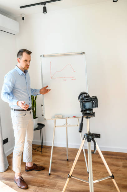 istock A guy in a smart casual wear records vlogs 1221622740