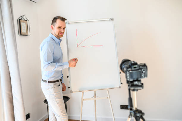istock A guy in a smart casual wear records vlogs 1221622763