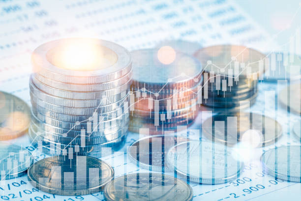 growing money saving and investment concept; double exposure of coins stack on bank account book with growing trend candle stick graph; blue tone - tax financial figures analyzing banking document imagens e fotografias de stock