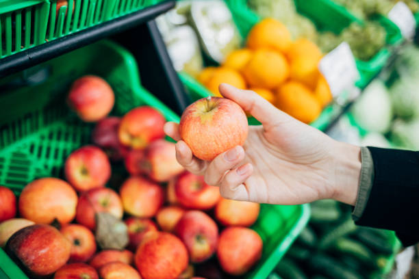 istock Close-up woman hand picking organic apple 1221625676