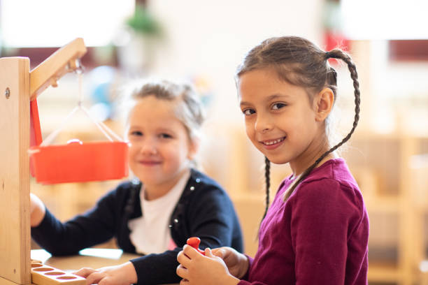 istock Cute girls playing in child care classroom 1221625714