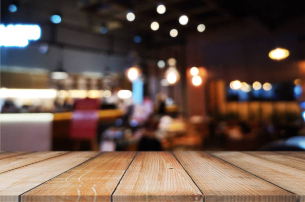 istock wooden table with abstract blurred background resturant lights used for display montage products mock up design. 1221627133