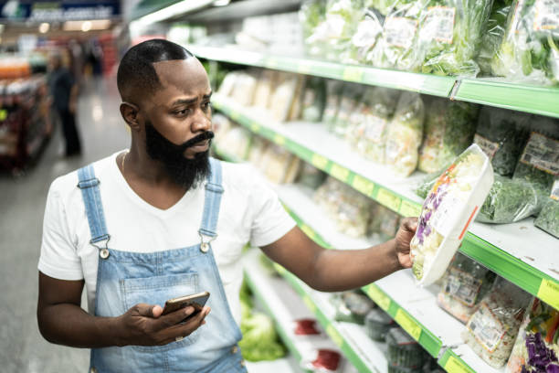 istock Man buying at supermarket using mobile phone 1221627609