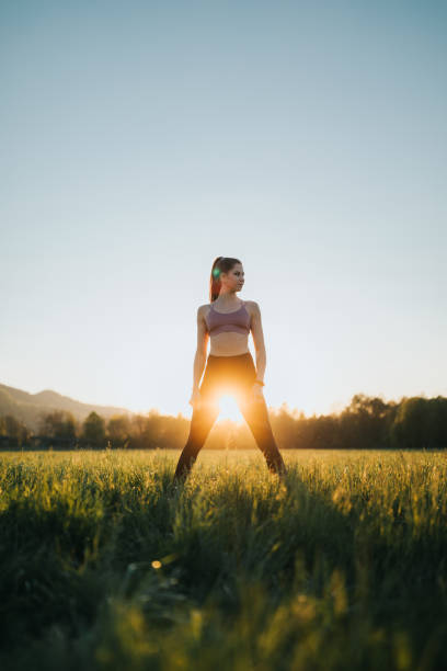 istock Young sportswoman standing confidently on a field at sunset 1221631279
