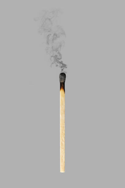 vertical burned match with smoke isolated on gray background - brunt imagens e fotografias de stock