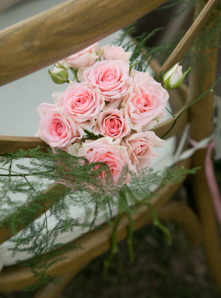 istock wedding flower arrangements on back of chairs 1221631679