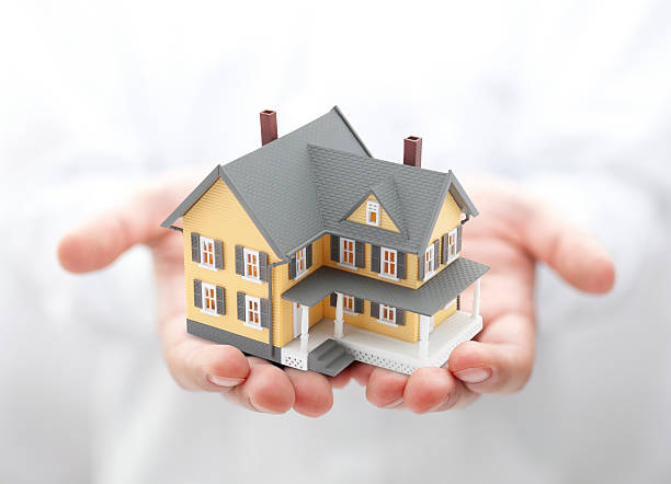 istock Yellow house in hands 122163188